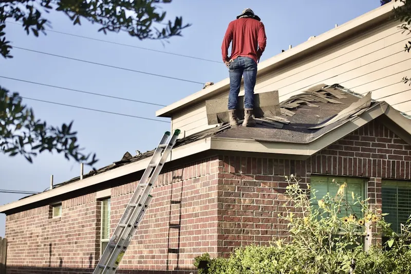 Professional roofer working on a residential roof in Fairmount